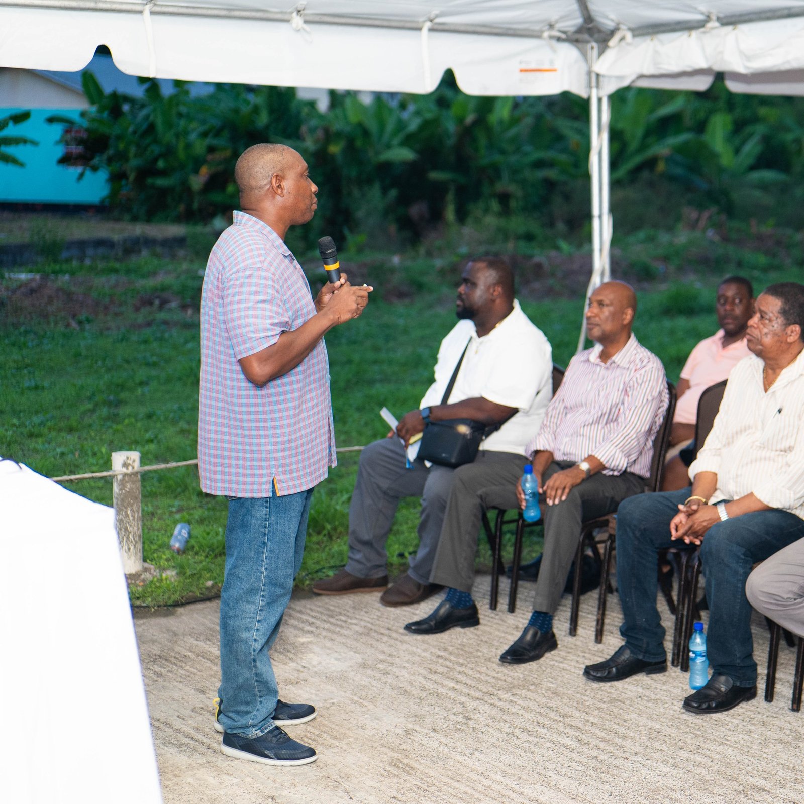 A man presenting the project during the community meeting.