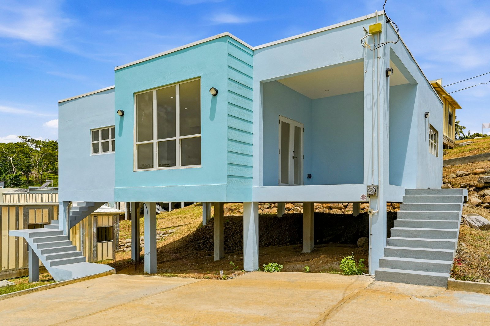 Allspice design, Lot 128: three-quarter exterior showing the porch, entry steps and raised structure.
