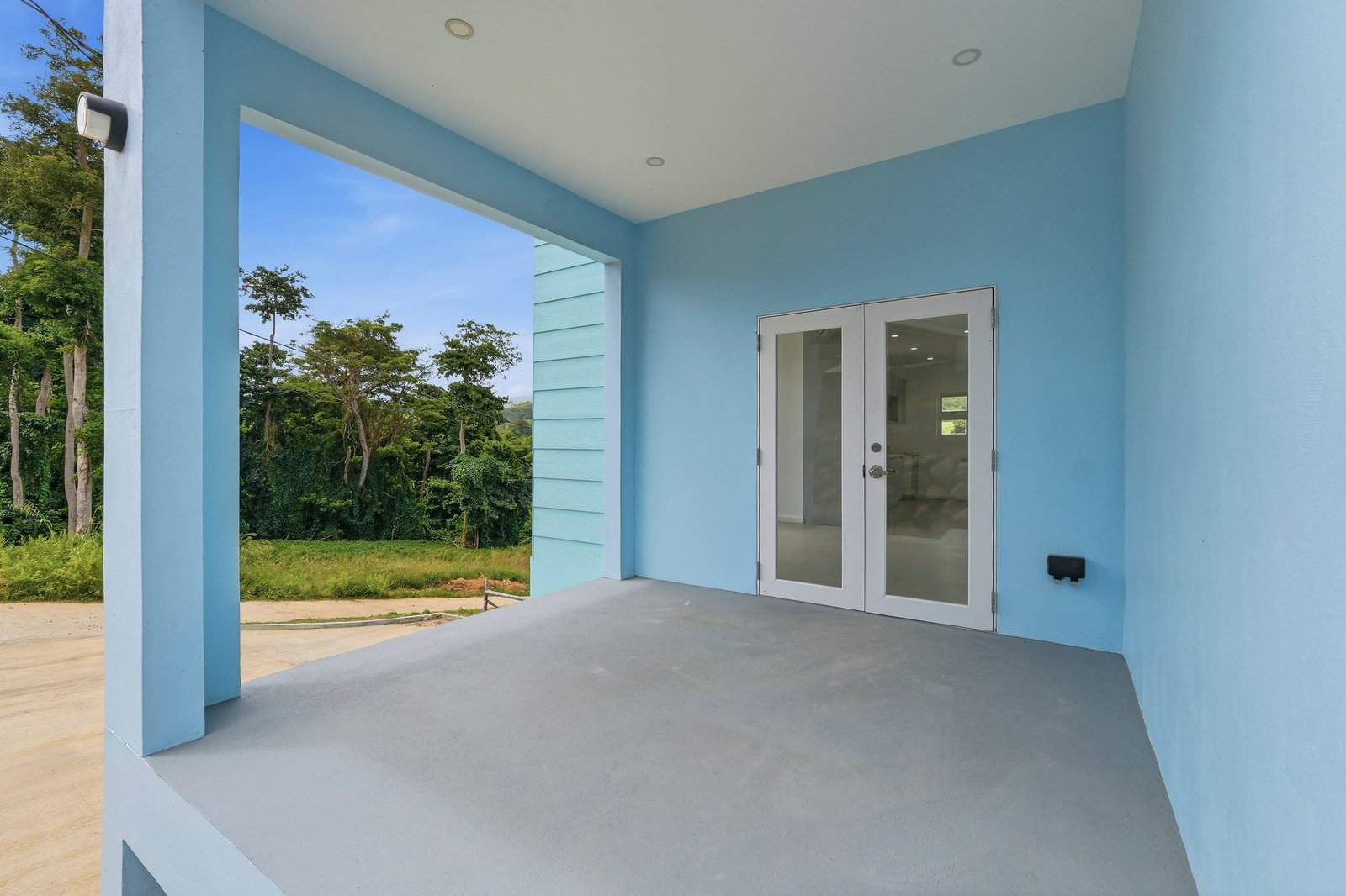 Allspice design, Lot 128: covered blue entry porch and glazed doorway.