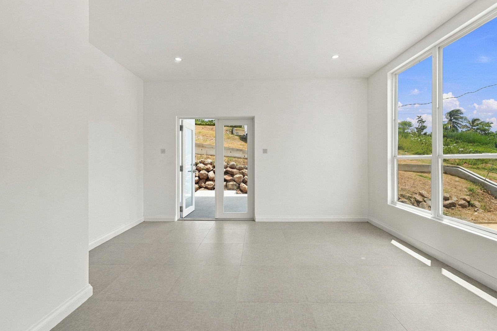 Allspice design, Lot 128: living area looking toward the glazed entrance and large front window.