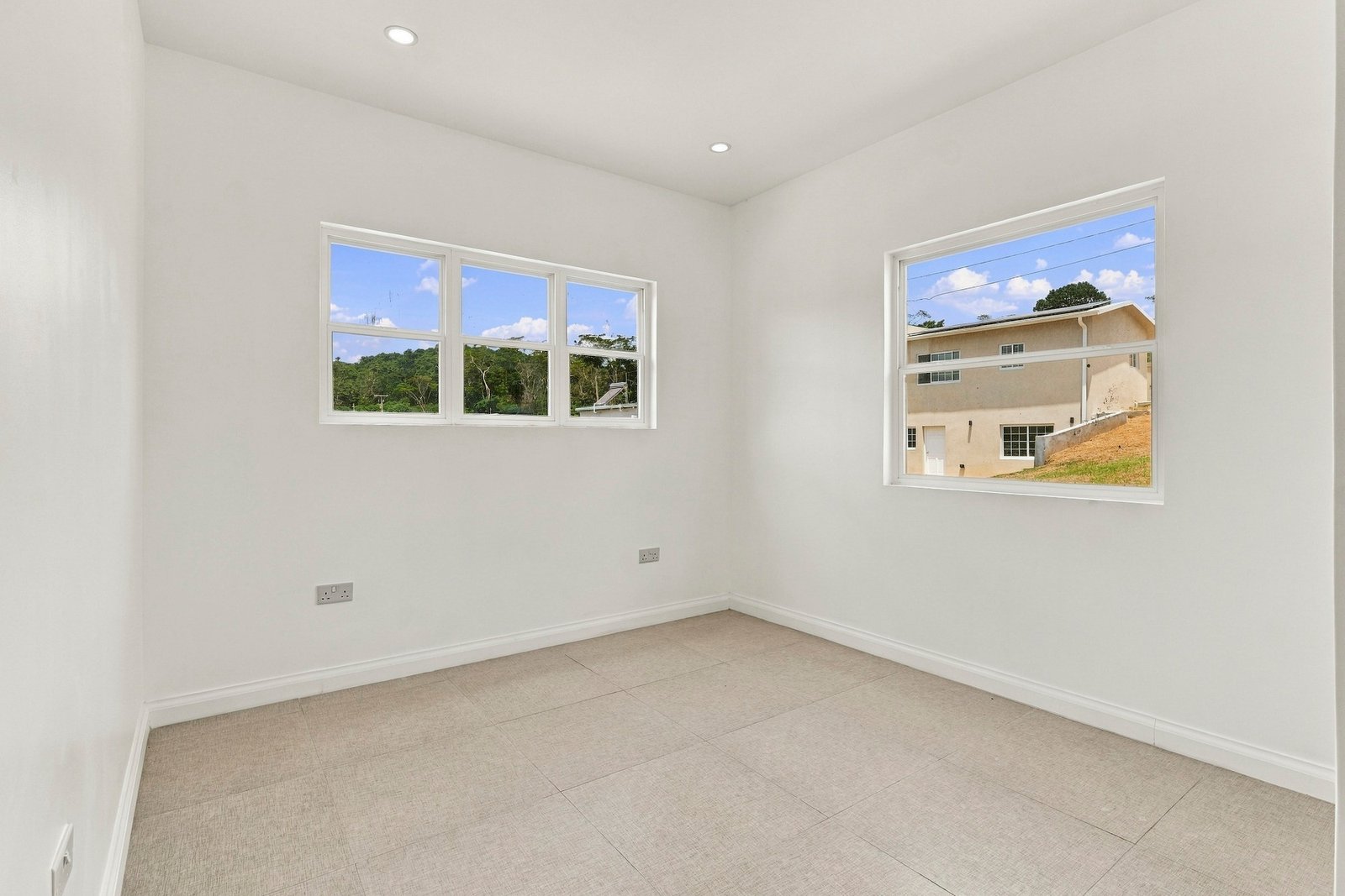 Allspice design, Lot 128: unfurnished room with wide and smaller windows on adjoining walls.