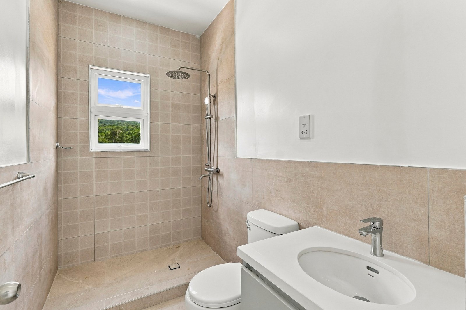 Allspice design, Lot 128: bathroom with a vanity, toilet and tiled shower beneath a window.
