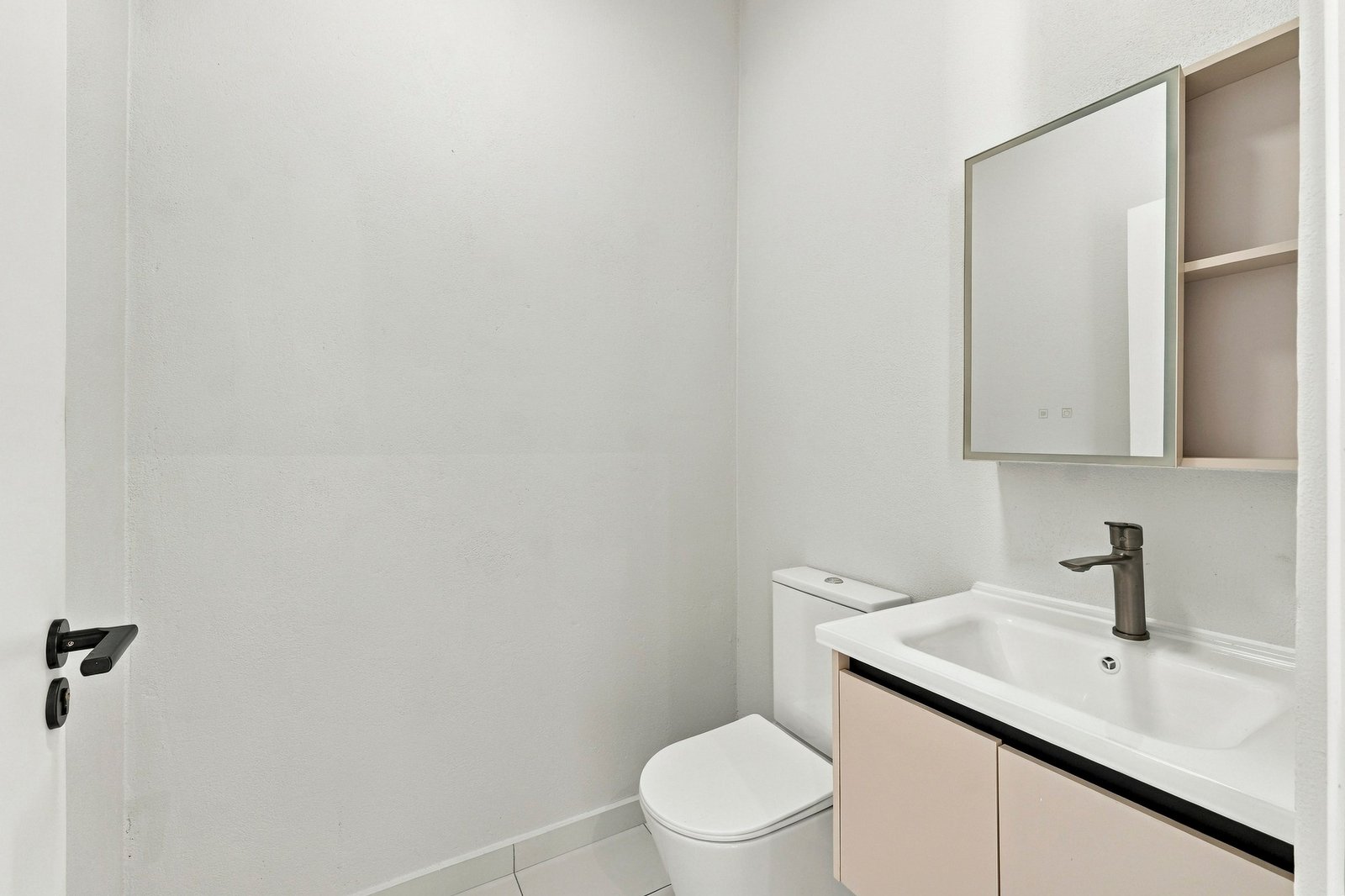 Bayleaf design, Lot 123: compact bathroom with a toilet, vanity and mirror cabinet.