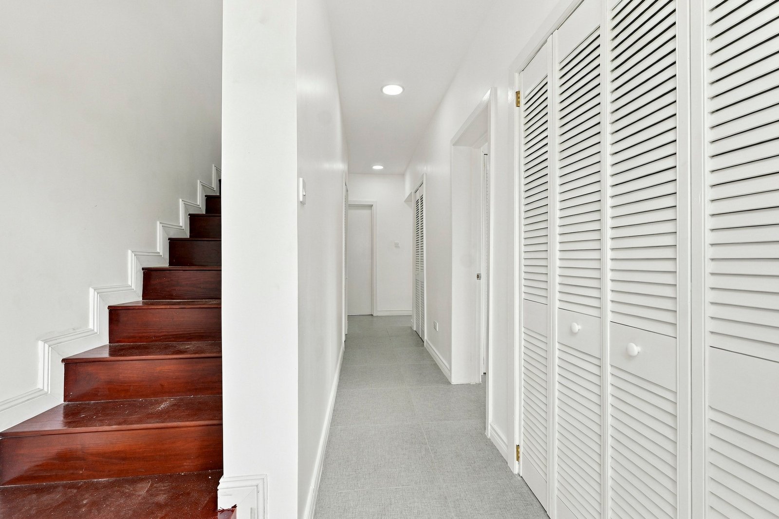 Interior hallway in the Clove home on Lot 116, with timber stair treads and white louvred storage doors.