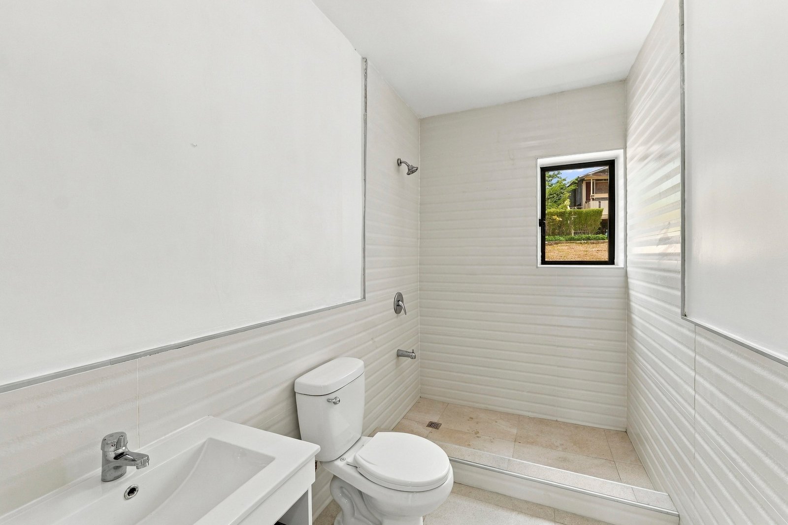 Bathroom in the Clove home on Lot 130, with a white basin, toilet and tiled shower area.
