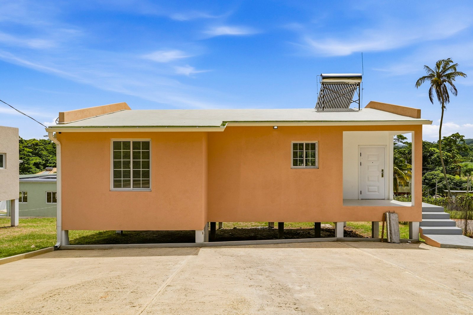 Coconut design, Lot 113: front exterior of the orange house with the entry porch and steps.