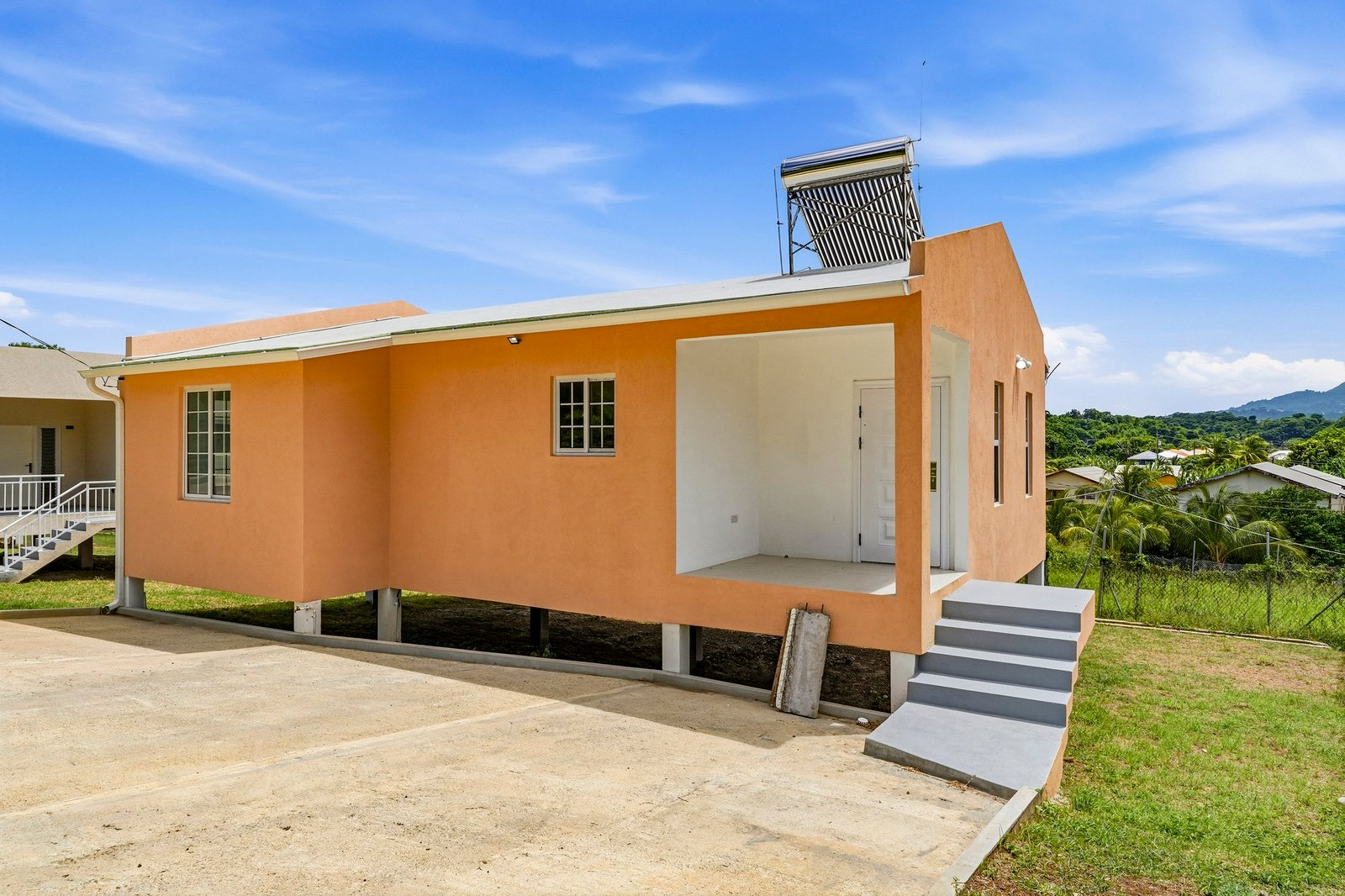 Coconut design, Lot 113: three-quarter exterior showing the front porch and entry steps.