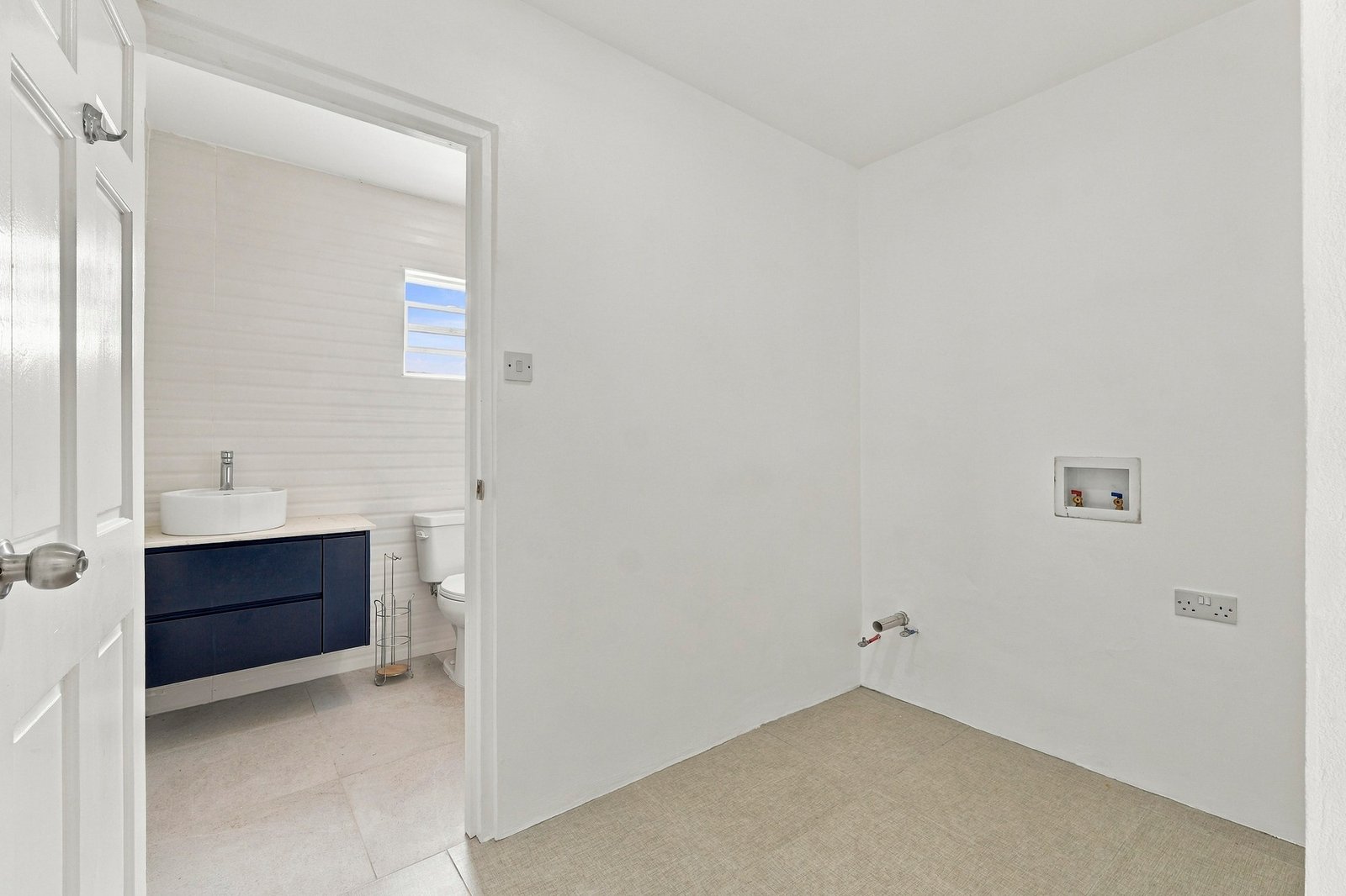 Coconut design, Lot 113: utility area with wall connections beside the bathroom doorway.
