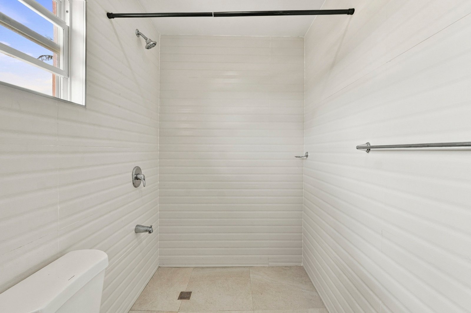 Coconut design, Lot 113: white-tiled shower area with a small window.