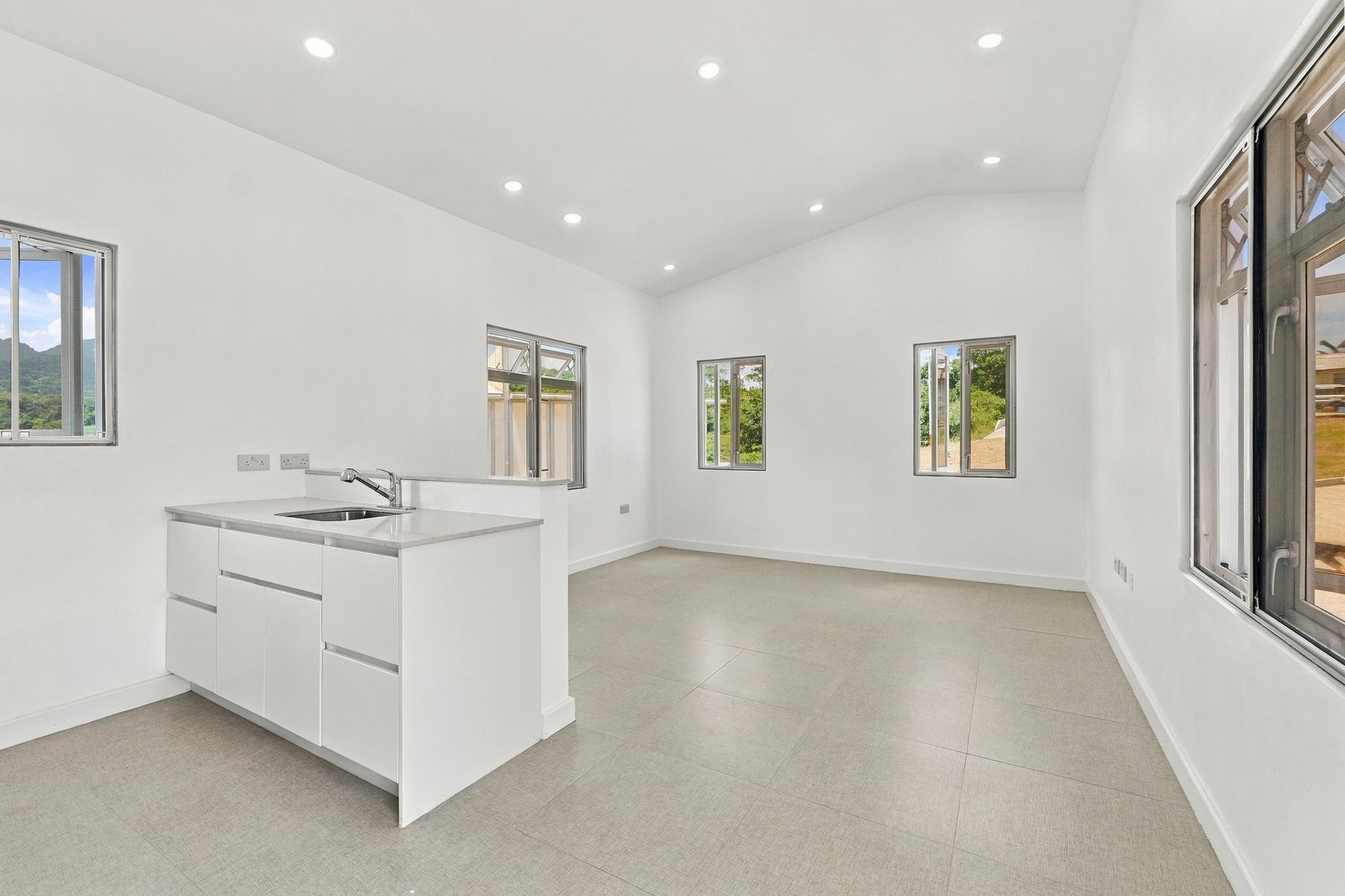 Hibiscus design, Lot 131: open-plan living area and white kitchen peninsula.