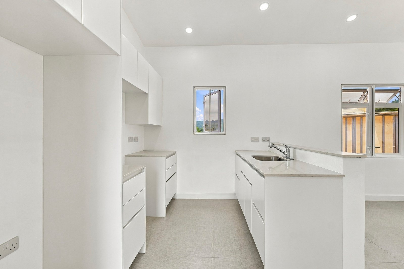 Hibiscus design, Lot 131: white kitchen cabinets, peninsula and sink.