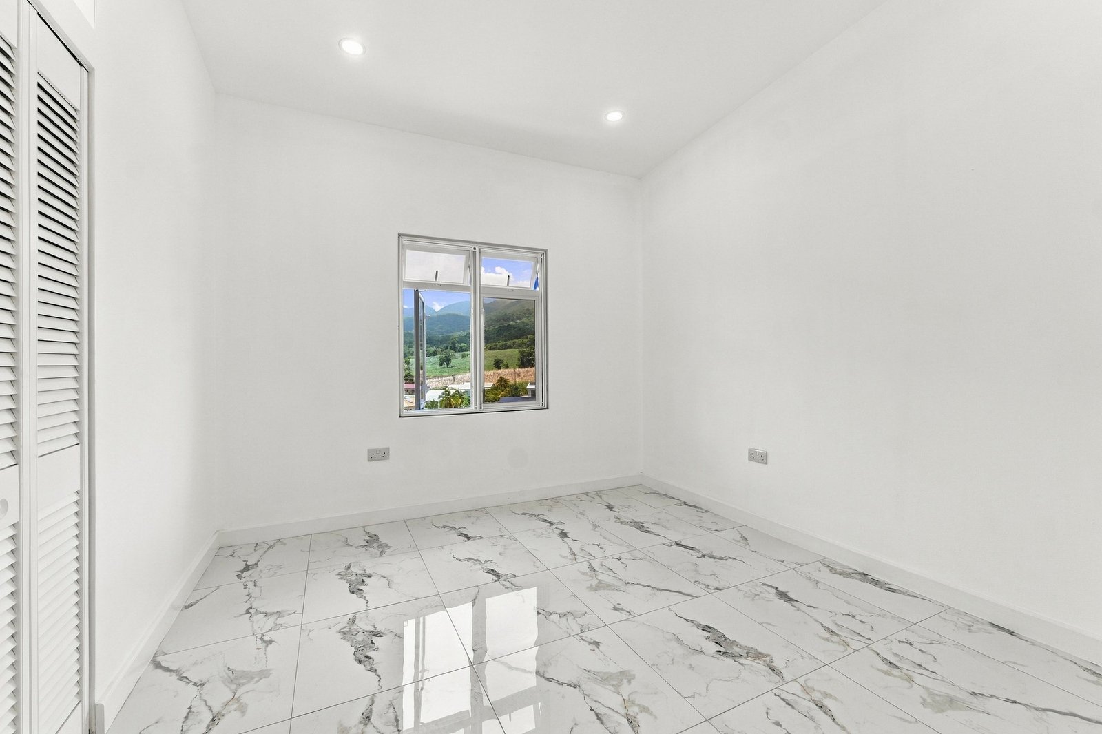 Hibiscus design, Lot 131: unfurnished room with a window, built-in storage and marble-pattern floor tiles.