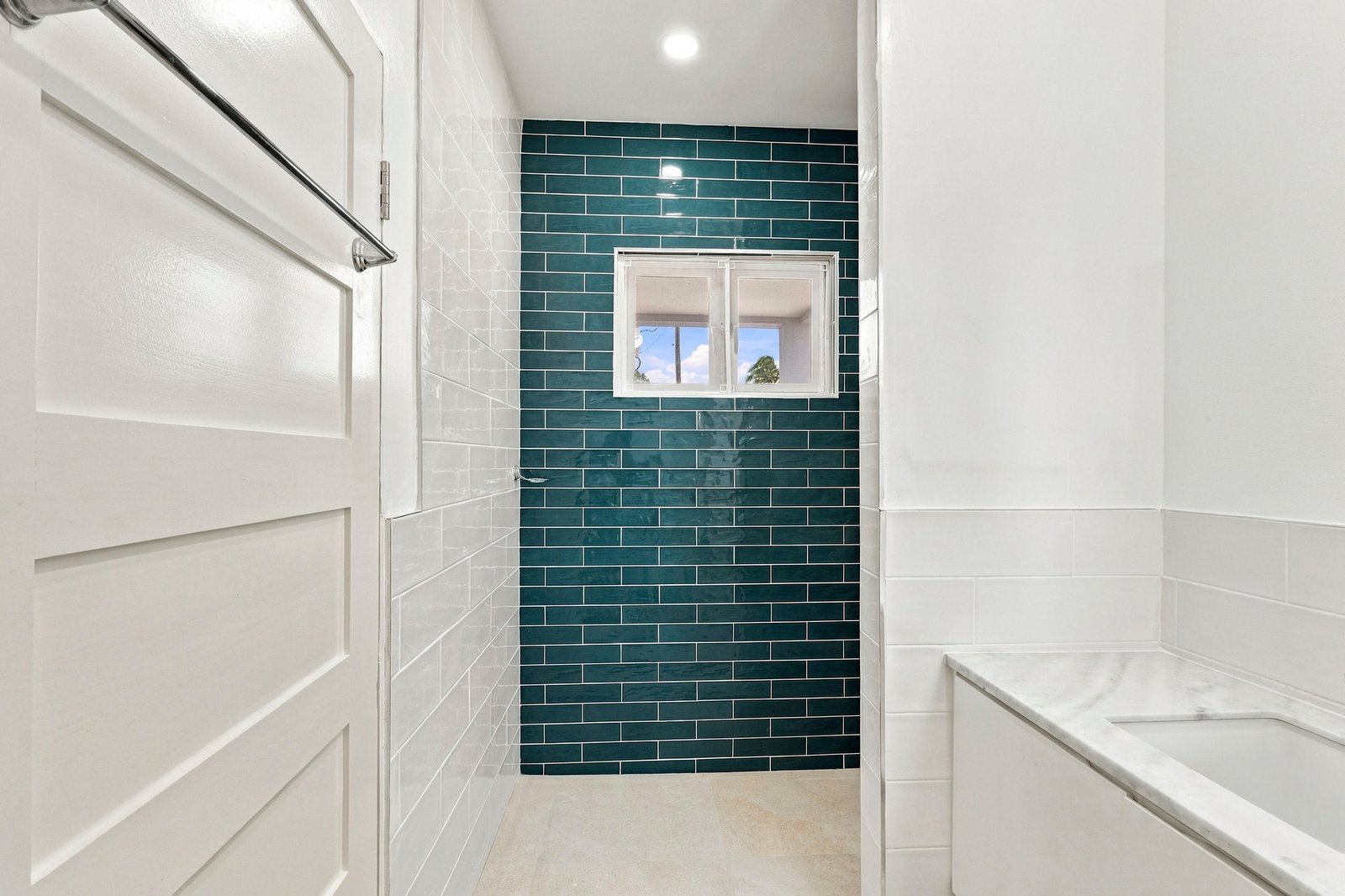 Hibiscus design, Lot 131: bathroom with a vanity and dark green tiled shower wall.