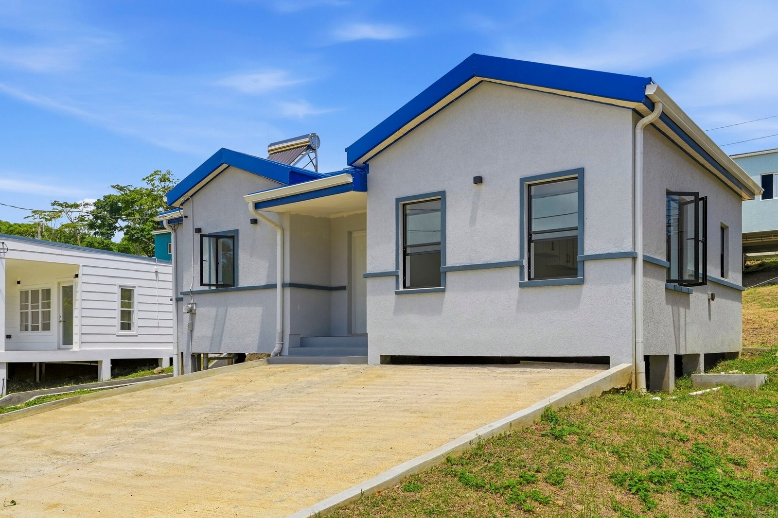Sapodilla design, Lot 122: three-quarter exterior showing the front entrance and right side.