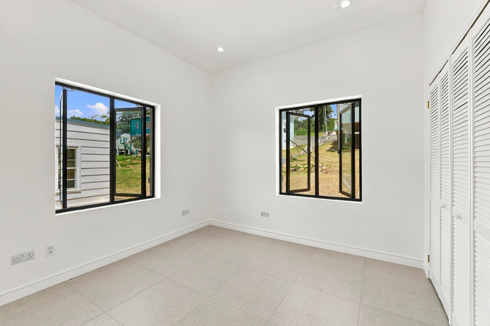 Sapodilla design, Lot 122: unfurnished room with two windows and built-in storage.